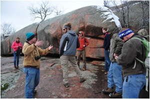 Hoffman Institute staff member Benjamin Miller (second from left) explains how the Elephant Rocks formed millions of years ago to WKU students (from left) Michelle Foley, Adam Aldridge, Brent Eberhard, Brian Ahlers, Paul Shively and Ben Rafferty. 
