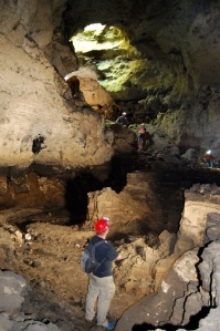 A view from below of the collapsed entrance, inside the cave, with perspective of its size provided by director Ed Booth in the foreground. (Photo by Tom Turner)  