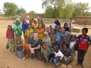 A group of Songhai women and children pose for a picture with WKU's Jonathan (Joneo) Oglesby after completing a group study in the remote village of Ganguel. 