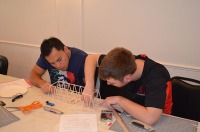 Balsa wood bridge construction during competition: Franklyn Perez and Tyler Baker.