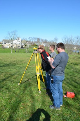 Surveying competition (left to right) Daniel Hammer, Jacob Cornett, and Nathan Hughes (front).